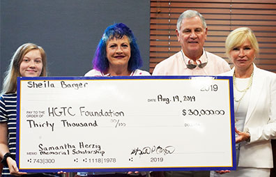 Ms. Sheila Barger presents $30,000 check to HGTC Foundation for Academic Angels Scholarship in memory of her daughter, Samantha Herzig. (left to right) Erica Miller, best friend of Samantha Herzig;  Sheila Barger, mother of Samantha Herzig;  Neyle Wilson, Foundation President & CEO; and Dr. Marilyn M. Fore, HGTC President.  