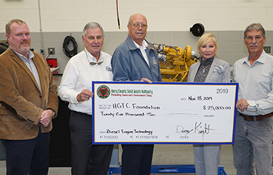 Danny Knight (center) presents $25,000 check to the HGTC Foundation for the Diesel Engine Technology program