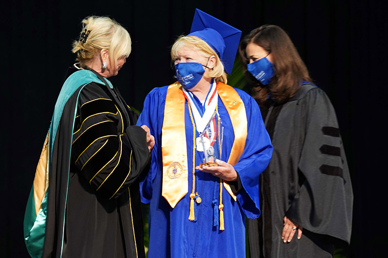 Ola Watson receiving her degree.