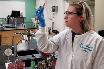 female student looking at a blood sample