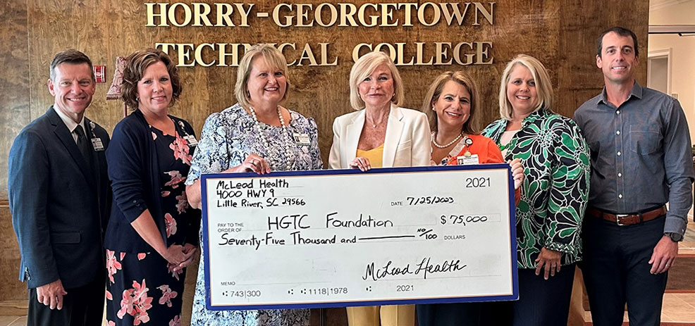 a check is presented to the HGTC foundation