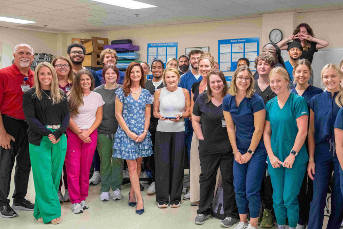 Dr. Nancy Lynch, center, receives the 2026 Adjunct Faculty of the Year Award from Dr. Lori Heafner, HGTC vice president for Academic Affairs, alongside students from the Physical Therapist Assistant program.