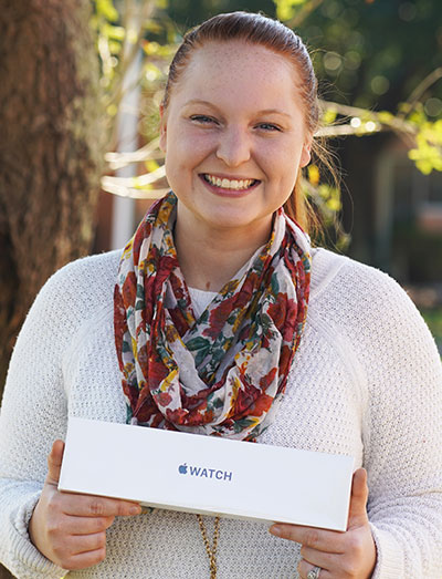 Laura holding Apple Watch