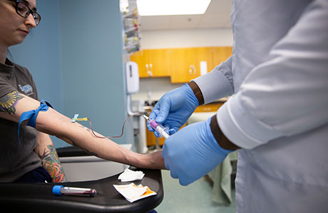  nurse draws blood from a patient