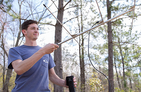 a forestry student uses radio equipment
