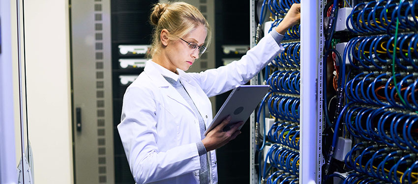 a girl stands in front of a networking computer